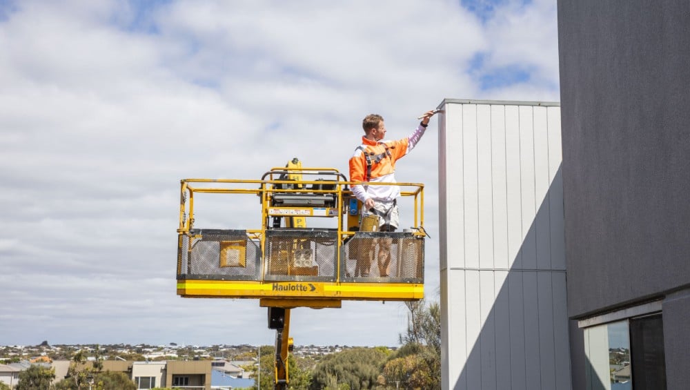 Higgins painter in an elevated work platform.